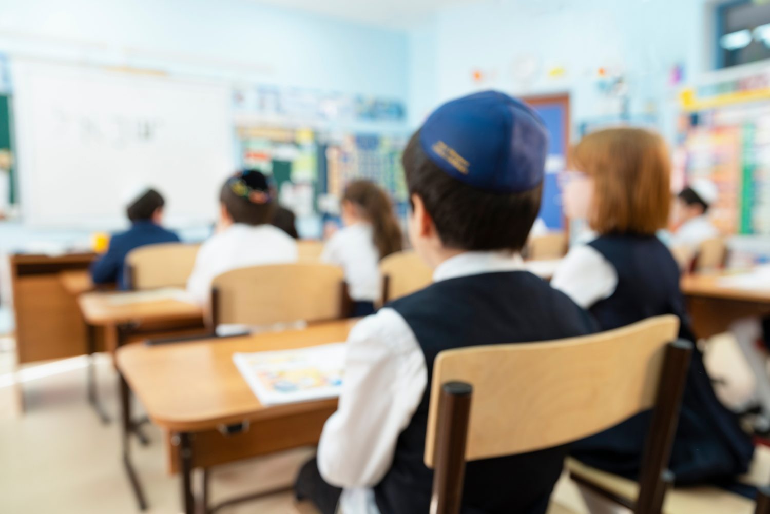 Children sitting at desks in a classroom at a Jewish school