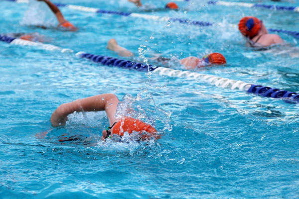 Piranhas swim team members swimming in the pool during a competition