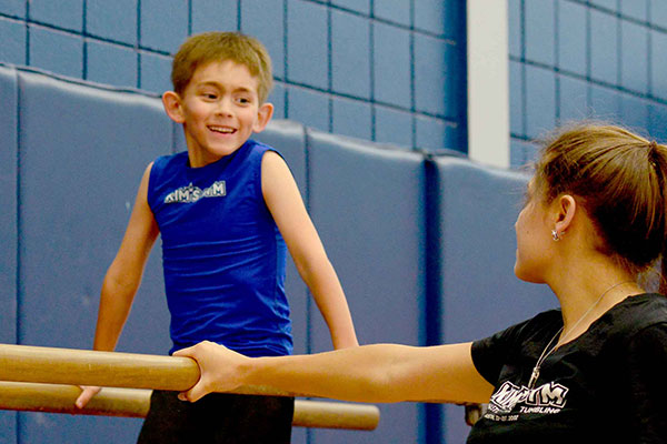 A boy practices gymnastics during a private lesson.