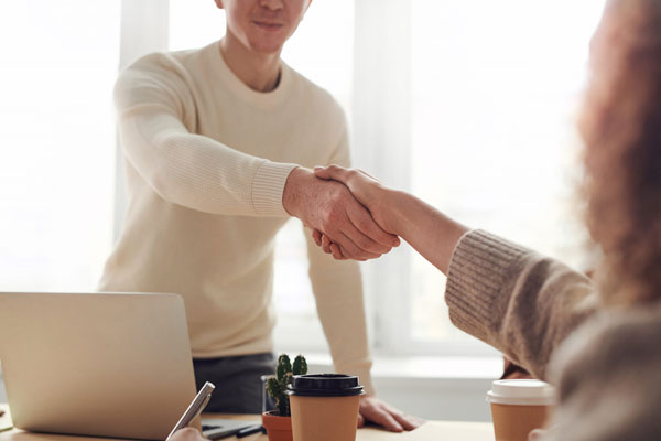 Two people meeting and shaking hands