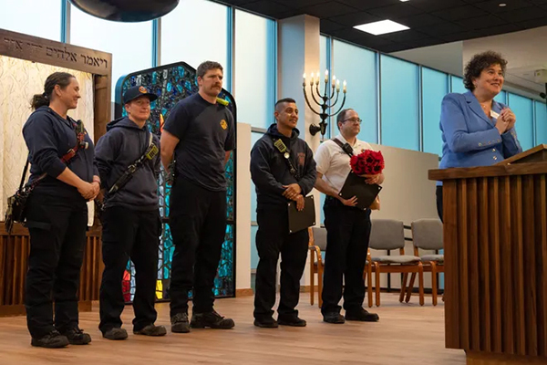 Members of the Austin Fire Department receive a standing ovation by the members of Congregation Beth Israel for their part in putting out the fire that damaged the synagogue in 2021, in Austin, Texas on Wednesday, Nov. 1, 2023. Credit: Evan L'Roy/Special to American-Statesman