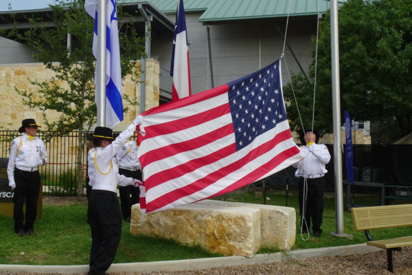 From left to right: Gregg Philipson holding bugle; Alana Pompa and Bob Kaplan beginning to hoist the flag. Credit: Steve Krant