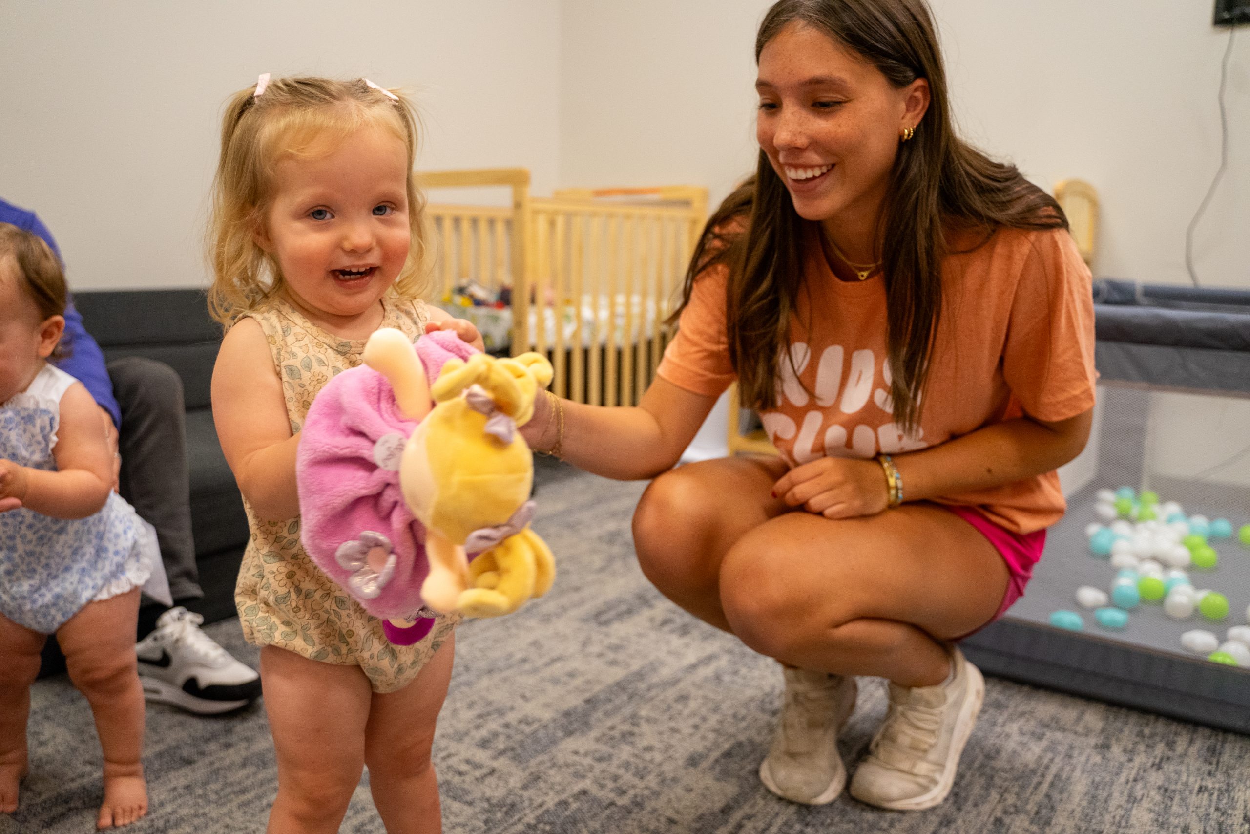 A young woman plays with toys with preschool boy