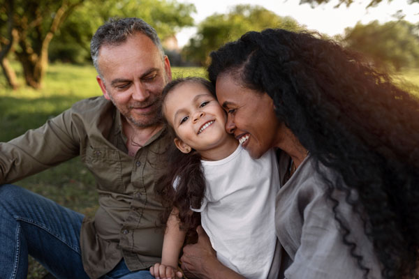 family mom and dad holding kid