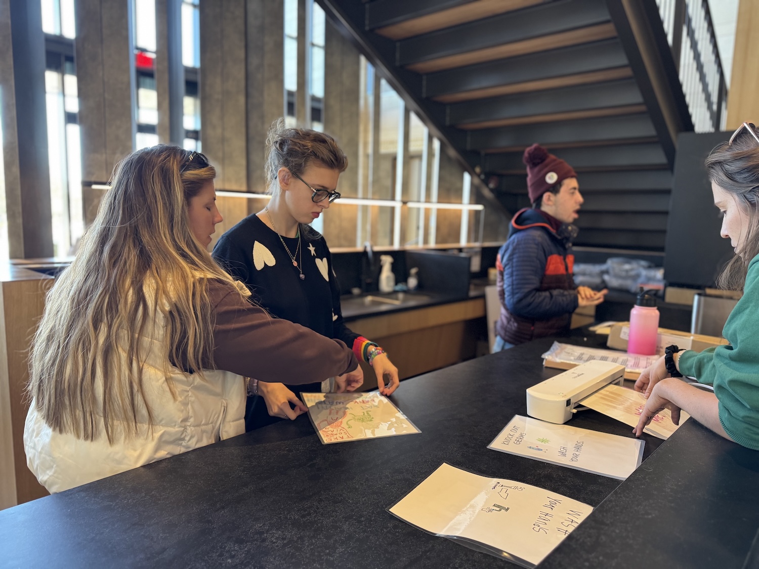 RAISE employees working at the welcome desk