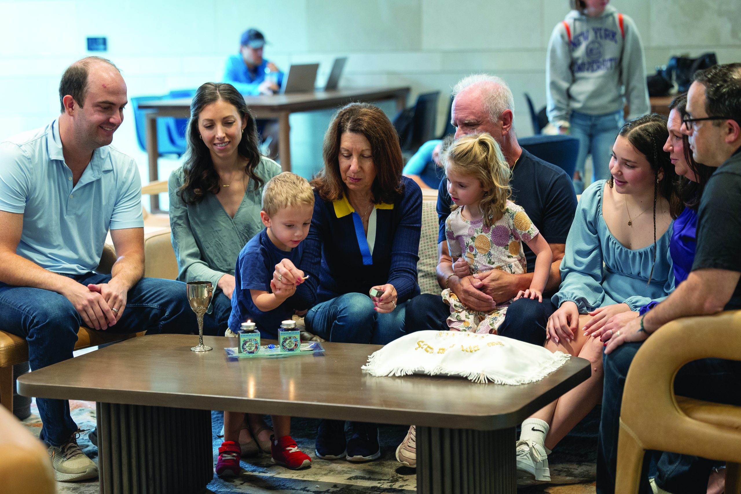 A grandfather reads a Rosh Hashanah book to his toddler granddaughter