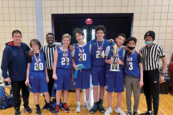 Coach Bobby and AJA's Boys Varsity Basketball team after winning the championship. Credit: Stephanie Cousins.