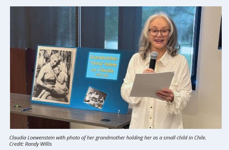 Claudia Loewenstein with photo of her grandmother holding her as a small child in Chile. Credit: Randy Willis