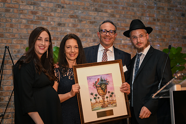 Janet and JP Newman honored with the Illuminator Award. L-R: Rebbetzin Mussy Levertov, Janet Newman, JP Newman, Rabbi Mendy Levertov. Credit: Alex Vise Janet and JP Newman honored with the Illuminator Award. L-R: Rebbetzin Mussy Levertov, Janet Newman, JP Newman, Rabbi Mendy Levertov. Credit: Alex Vise