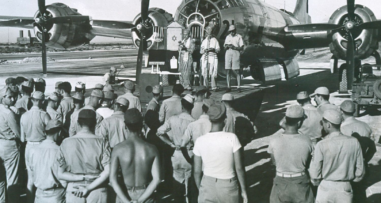 Jewish services held on Saipan in front of an Army Air Corps B-29 bomber shortly after Japan surrendered the Island in mid-1944.The service was conducted by (L to R) Chaplain Lt. Max Daina, Syracuse, NY, Sgt. Edward Slutsky, of New Haven, Conn., who acted as cantor, and Col. Solomon J. Zoller, New York City. Courtesy: The National Museum of American Jewish Military History
